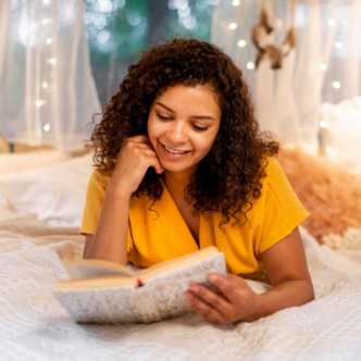 A smiling lady reading a book