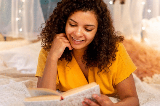 A smiling lady reading a book