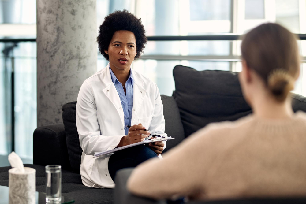 Psychologist in professional office speaking to a client.