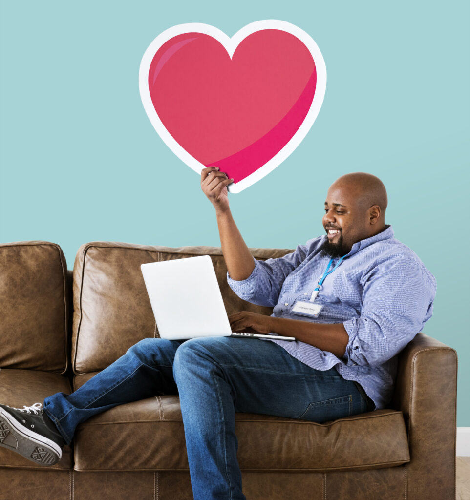 The Love Central - Black man working on laptop Balancing Career and Love: When Work Competes With Relationships