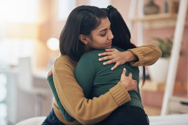 The Love Central - Cropped shot of two young women embracing each other at home First meeting safety tips