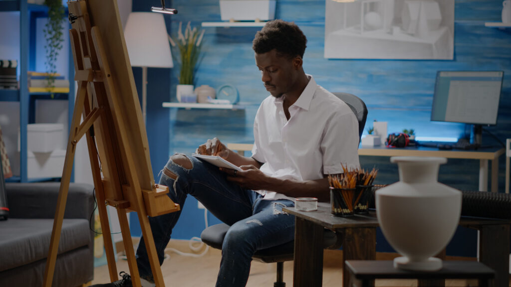 The Love Central - Person of african american ethnicity working on vase sketch The Love Central -